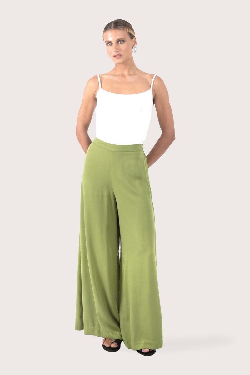 Woman wearing the Callie Palazzo Pants Green designed for effortless resortwear and tropical living, by By The Sea Bali
