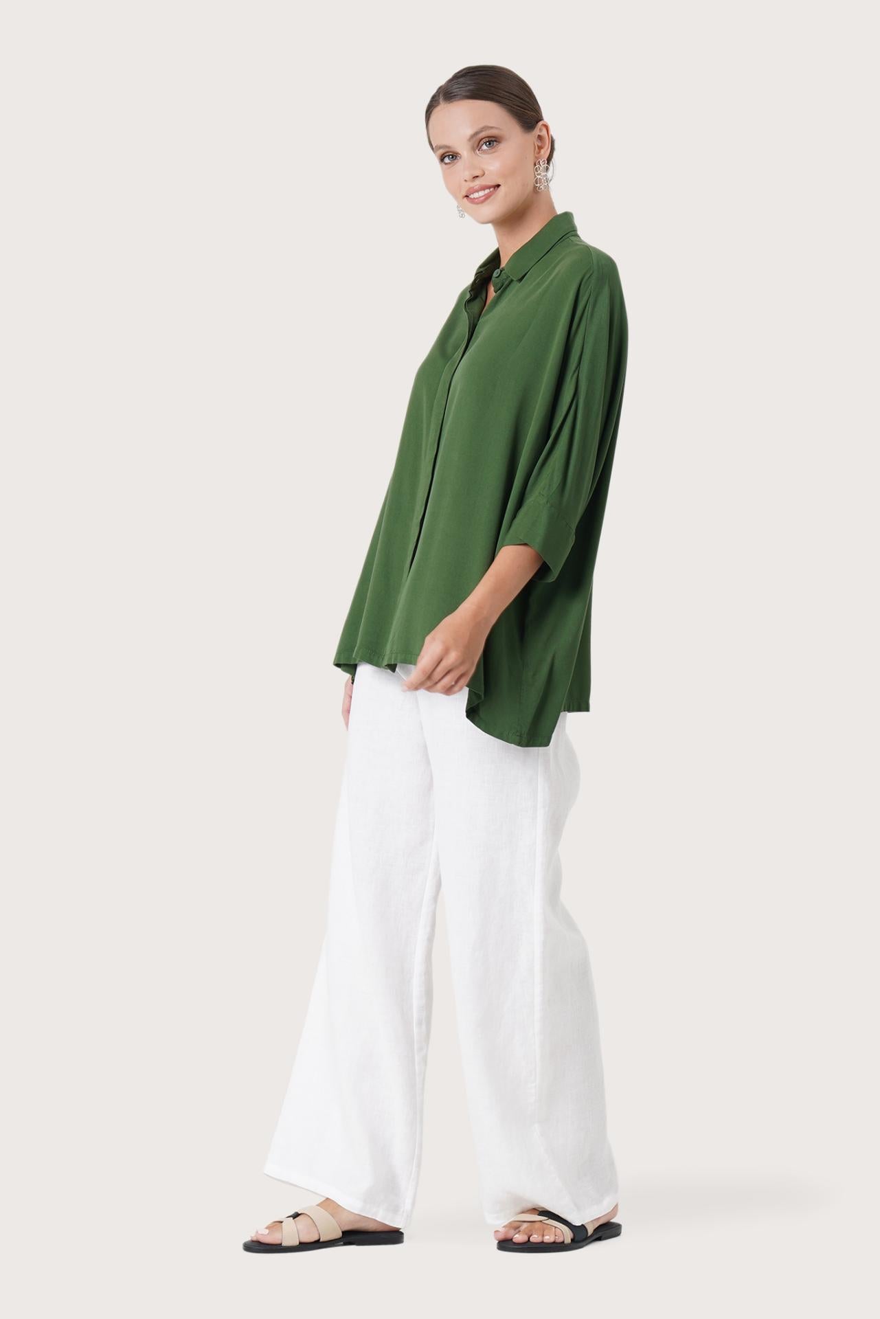 Side profile of the Candidasa Shirt Green showing its cut and natural movement.