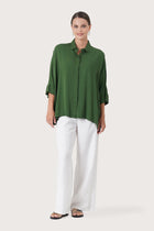 Woman wearing the Candidasa Shirt Green designed for effortless resortwear and tropical living by By The Sea Bali.