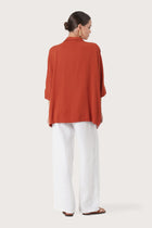 Back view of the Candidasa Shirt Red highlighting the garment shape and drape.