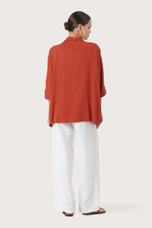Back view of the Candidasa Shirt Red highlighting the garment shape and drape.