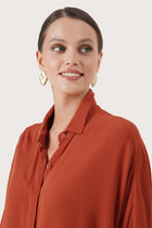Close up detail of the Candidasa Shirt Red highlighting craftsmanship and design features.