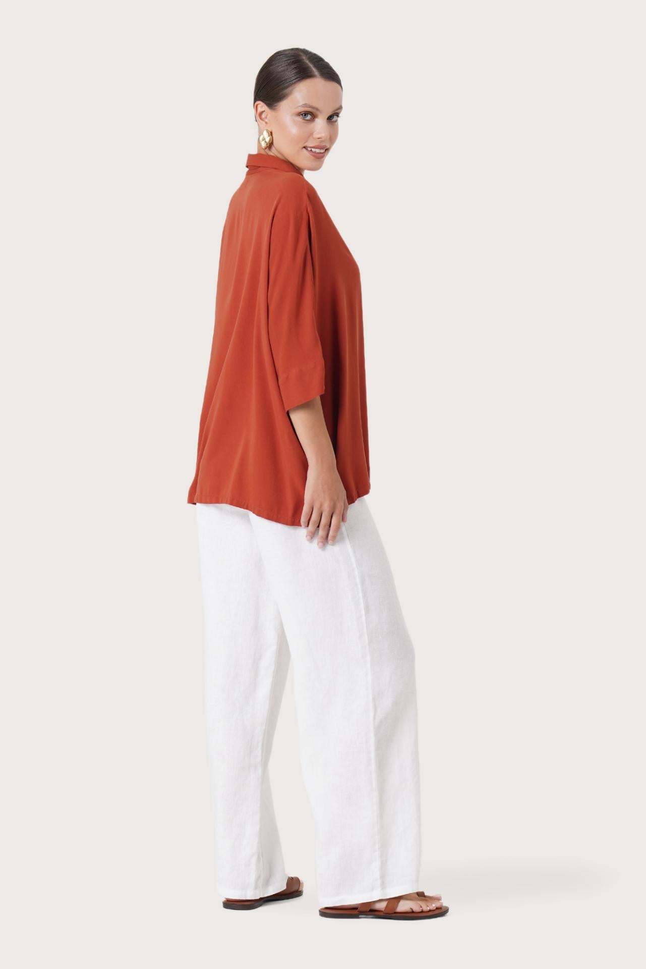 Side profile of the Candidasa Shirt Red showing its cut and natural movement.