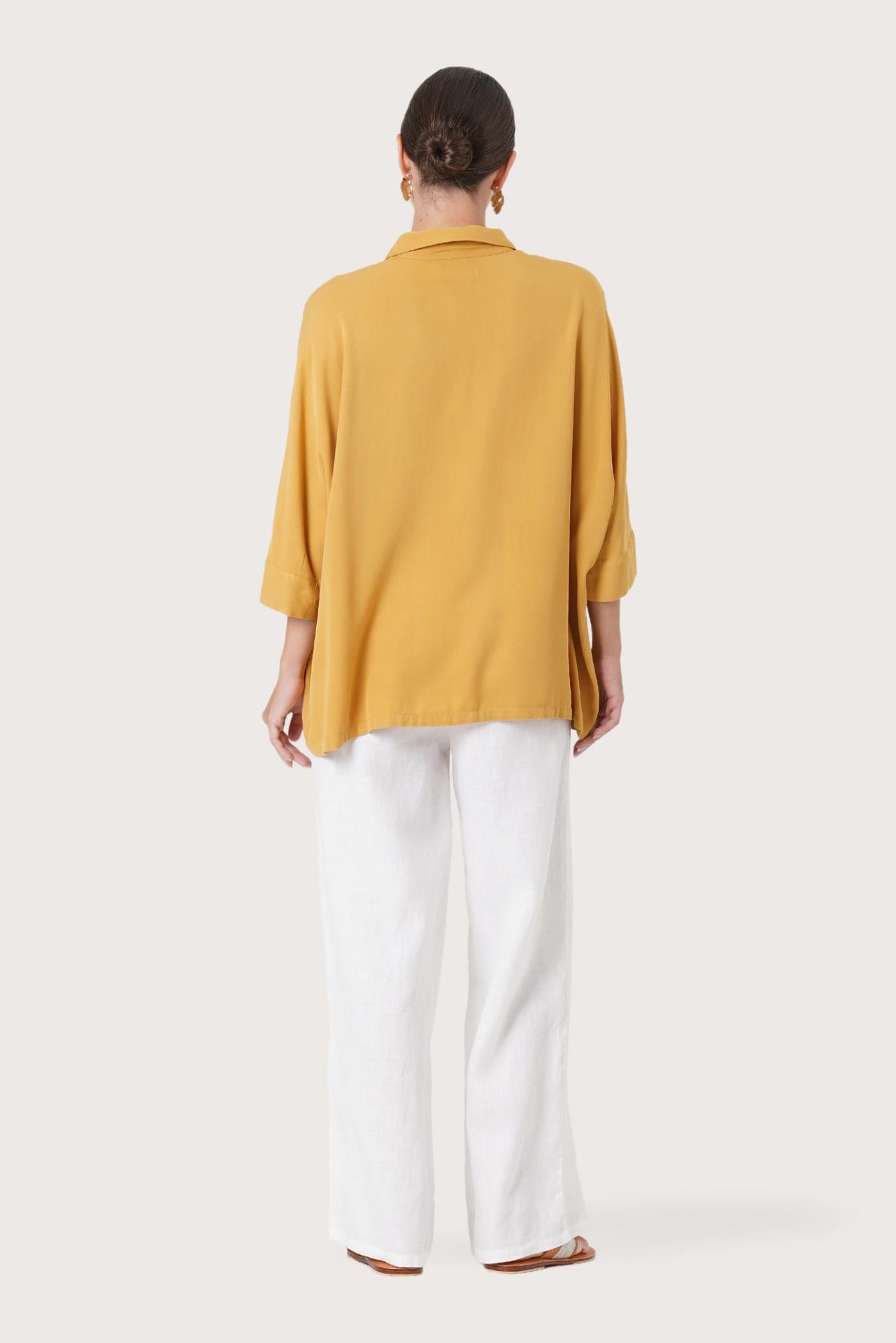 Back view of the Candidasa Shirt Yellow highlighting the garment shape and drape.