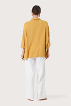 Back view of the Candidasa Shirt Yellow highlighting the garment shape and drape.
