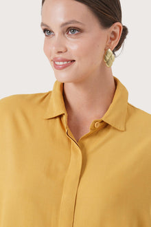 Close up detail of the Candidasa Shirt Yellow highlighting craftsmanship and design features.