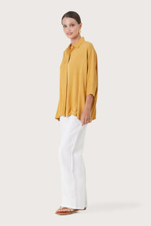 Side profile of the Candidasa Shirt Yellow showing its cut and natural movement.