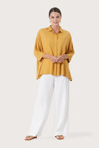 Woman wearing the Candidasa Shirt Yellow designed for effortless resortwear and tropical living by By The Sea Bali.