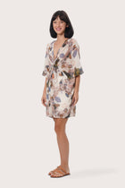 Refined back view of the Canna Short Kaftan in Oleander Creme print