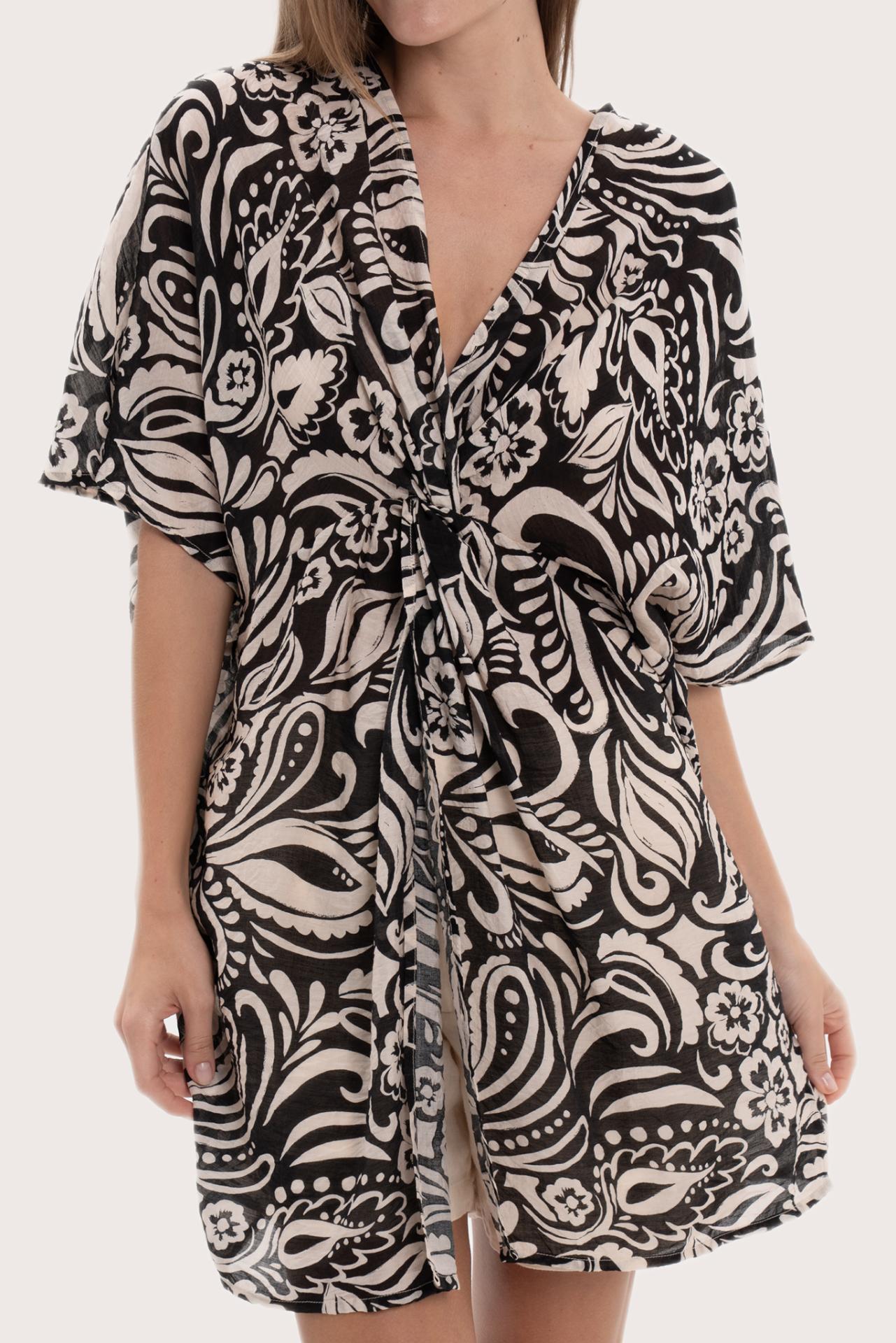 Close-up of the twisted front detail and paisley print on the black short kaftan