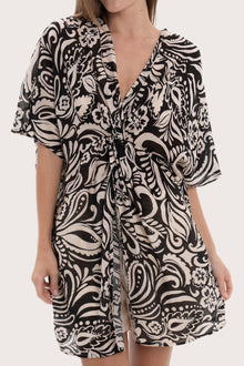 Close-up of the twisted front detail and paisley print on the black short kaftan