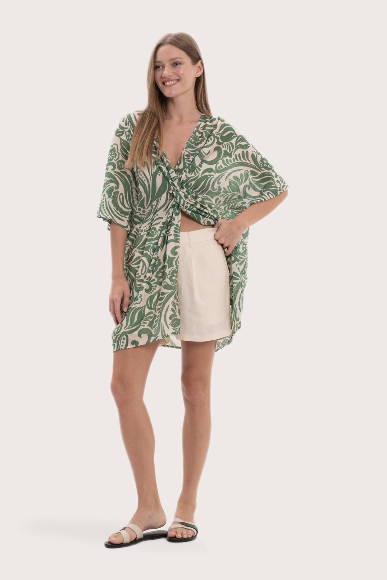 Side profile of the green paisley short kaftan showcasing its lightweight drape
