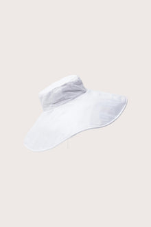 Elegant angled view of the Capri Linen Hat emphasizing its fluid brim and minimalist design