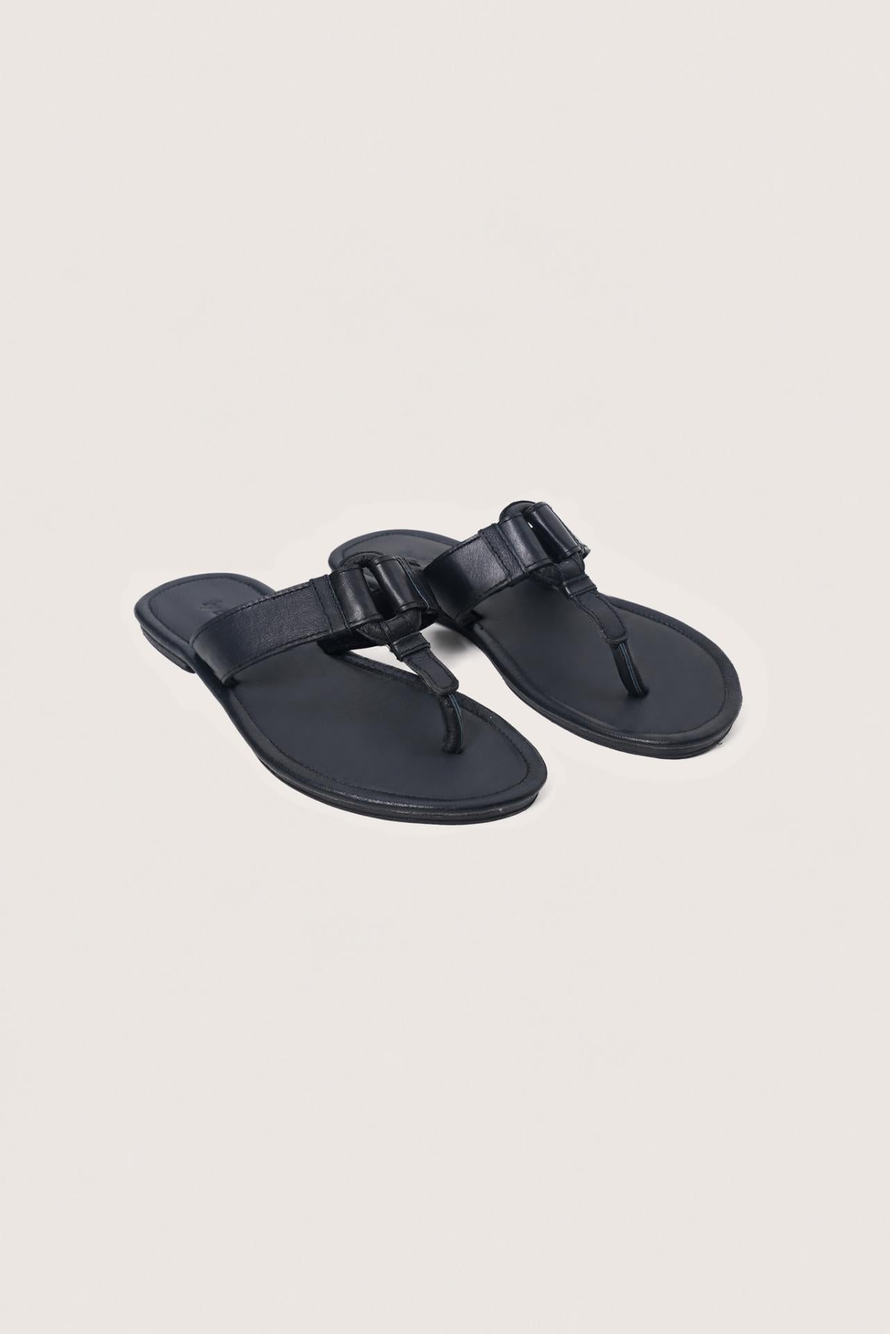Angled view of the black leather Cate sandals showcasing their elegant design