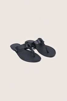 Angled view of the black leather Cate sandals showcasing their elegant design