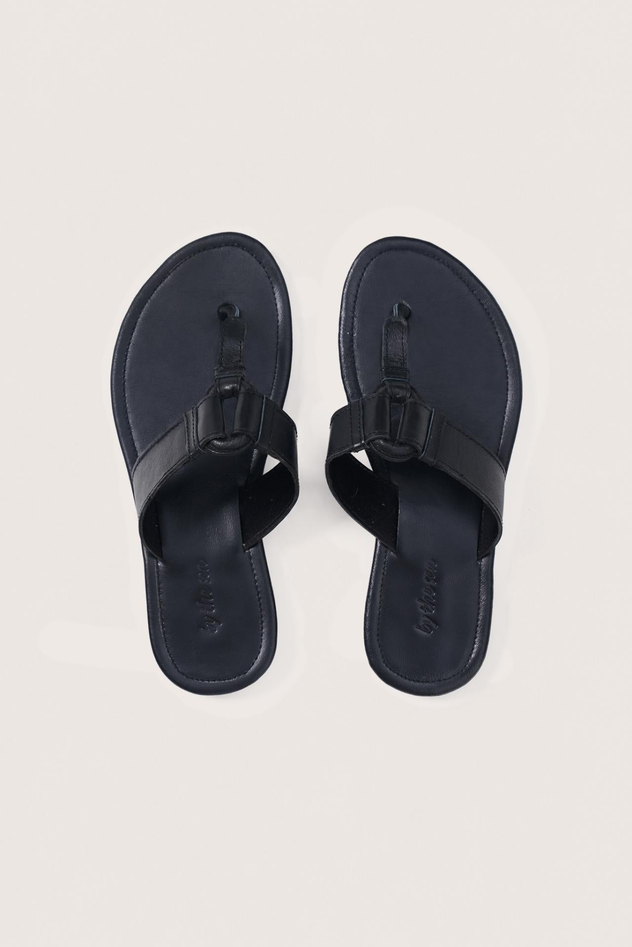 Black leather Cate sandals by By The Sea Bali displayed from the front