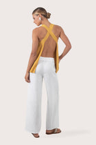 Back view highlighting the open-back design with cross straps and flowing lightweight rayon fabric