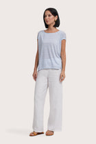 Side profile of the Cyra T-shirt Stripe Light Blue showing its cut and natural movement.