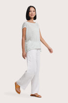 Side profile of the Cyra T-shirt Stripe Pastel Green showing its cut and natural movement.