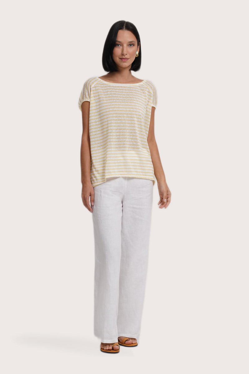 front view of a woman wearing the Cyra T-shirt Stripe Yellow designed for effortless resortwear and tropical living by By The Sea Bali.