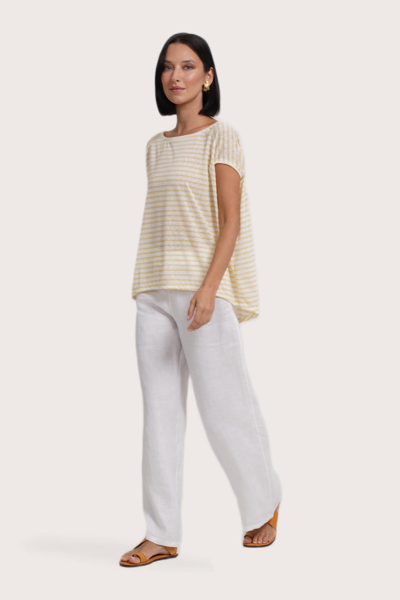 Side profile of the Cyra T-shirt Stripe Yellow showing its cut and natural movement.