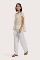 Side profile of the Cyra T-shirt Stripe Yellow showing its cut and natural movement.