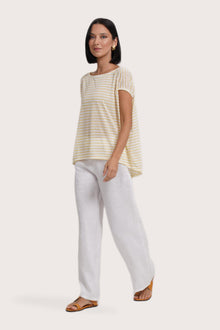 Side profile of the Cyra T-shirt Stripe Yellow showing its cut and natural movement.