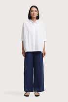 Woman wearing the Daria Cotton Shirt designed for effortless resortwear and tropical living by By The Sea Bali.