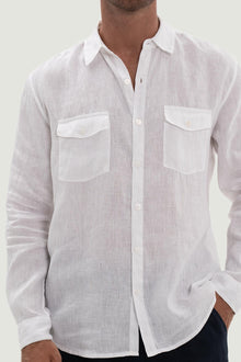 Close-up of the linen fabric texture and refined tailoring details on the white shirt