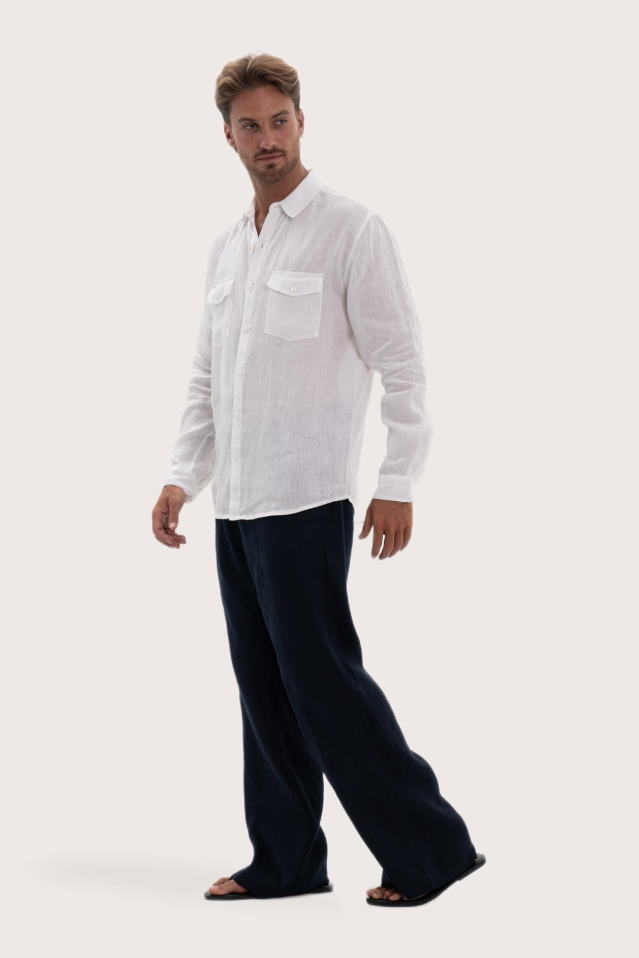 Side profile of the white linen shirt showcasing its effortless drape and fit