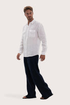 Side profile of the white linen shirt showcasing its effortless drape and fit