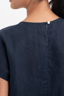 Back view of the Darya Linen Top Navy Blue highlighting the garment shape and drape.