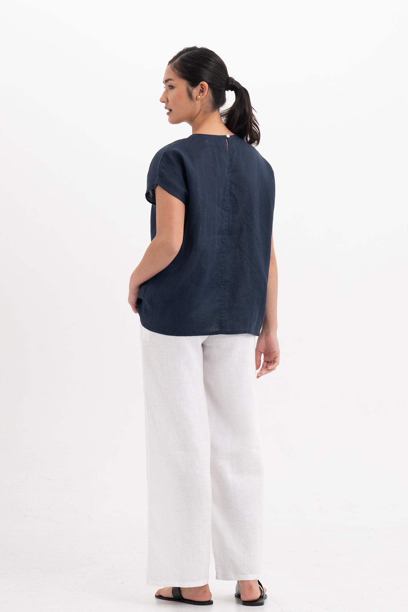 Back view of the Darya Linen Top Navy Blue highlighting the garment shape and drape.