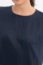 Close up detail of the Darya Linen Top Navy Blue highlighting craftsmanship and design features.