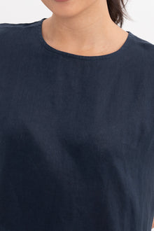 Close up detail of the Darya Linen Top Navy Blue highlighting craftsmanship and design features.