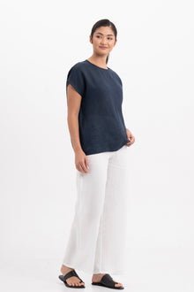 Side profile of the Darya Linen Top Navy Blue showing its cut and natural movement.
