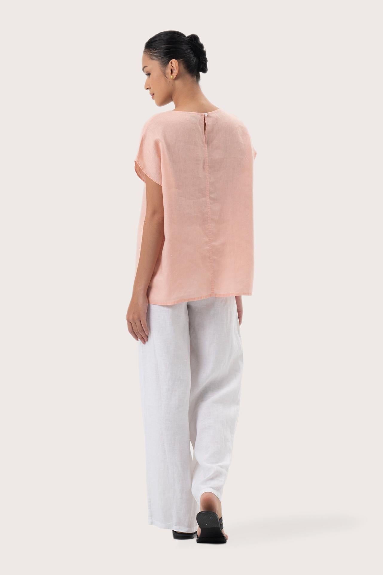 Back view of the Darya Linen Top pink highlighting the garment shape and drape.