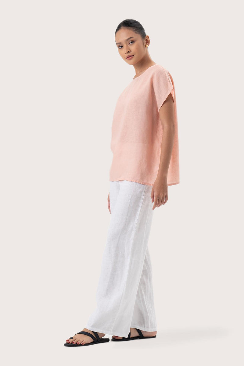 Side profile of the Darya Linen Top Pink showing its cut and natural movement
