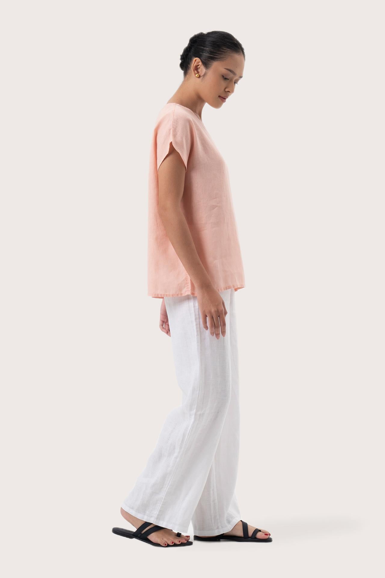 Side profile of the Darya Linen Top Pink showing its cut and natural movement.