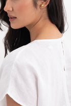Back view of the Darya Linen Top White highlighting the garment shape and drape.
