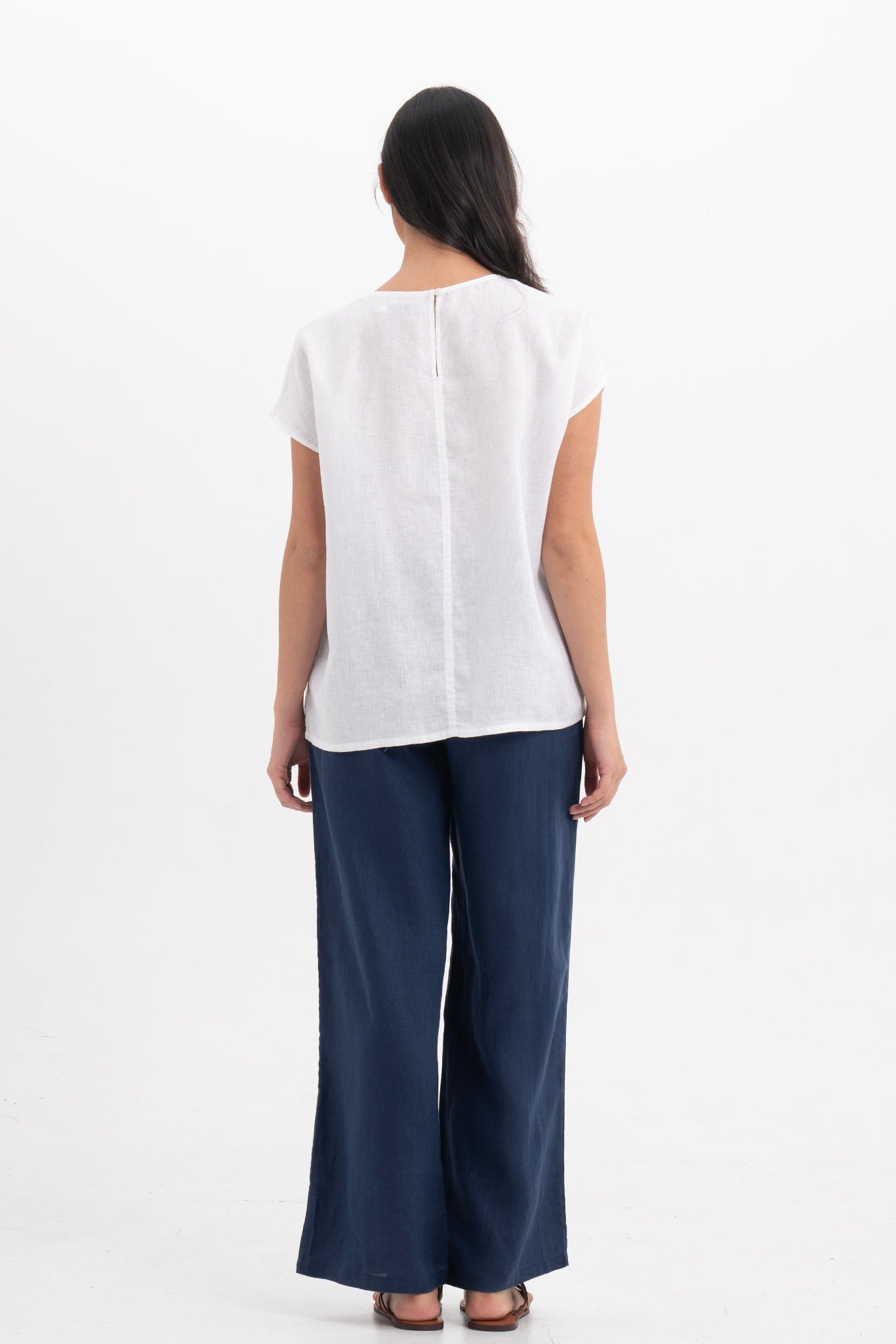 Back view of the Darya Linen Top White highlighting the garment shape and drape.