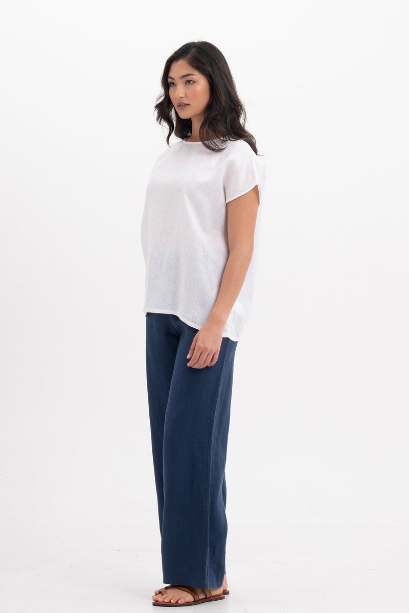 Side profile of the Darya Linen Top White showing its cut and natural movement.