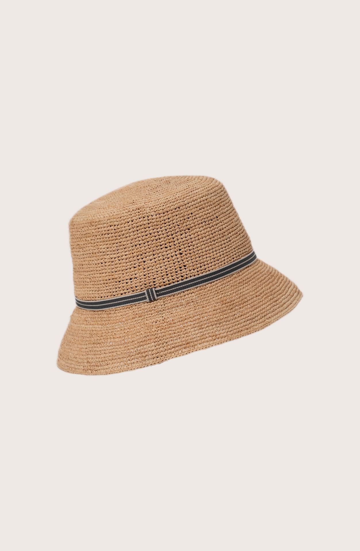 Model wearing the natural straw Dewy hat with a grey ribbon by By The Sea Bali