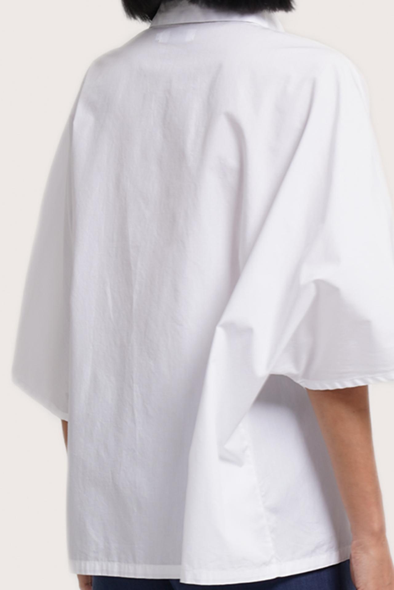 Back view of the Egra Loose Cotton Shirt White highlighting the garment shape and drape.