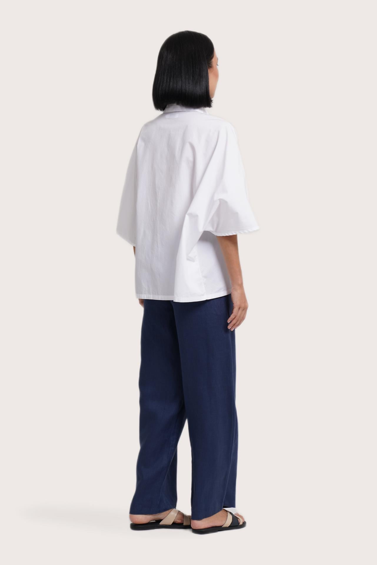 Back view of the Egra Loose Cotton Shirt White highlighting the garment shape and drape.