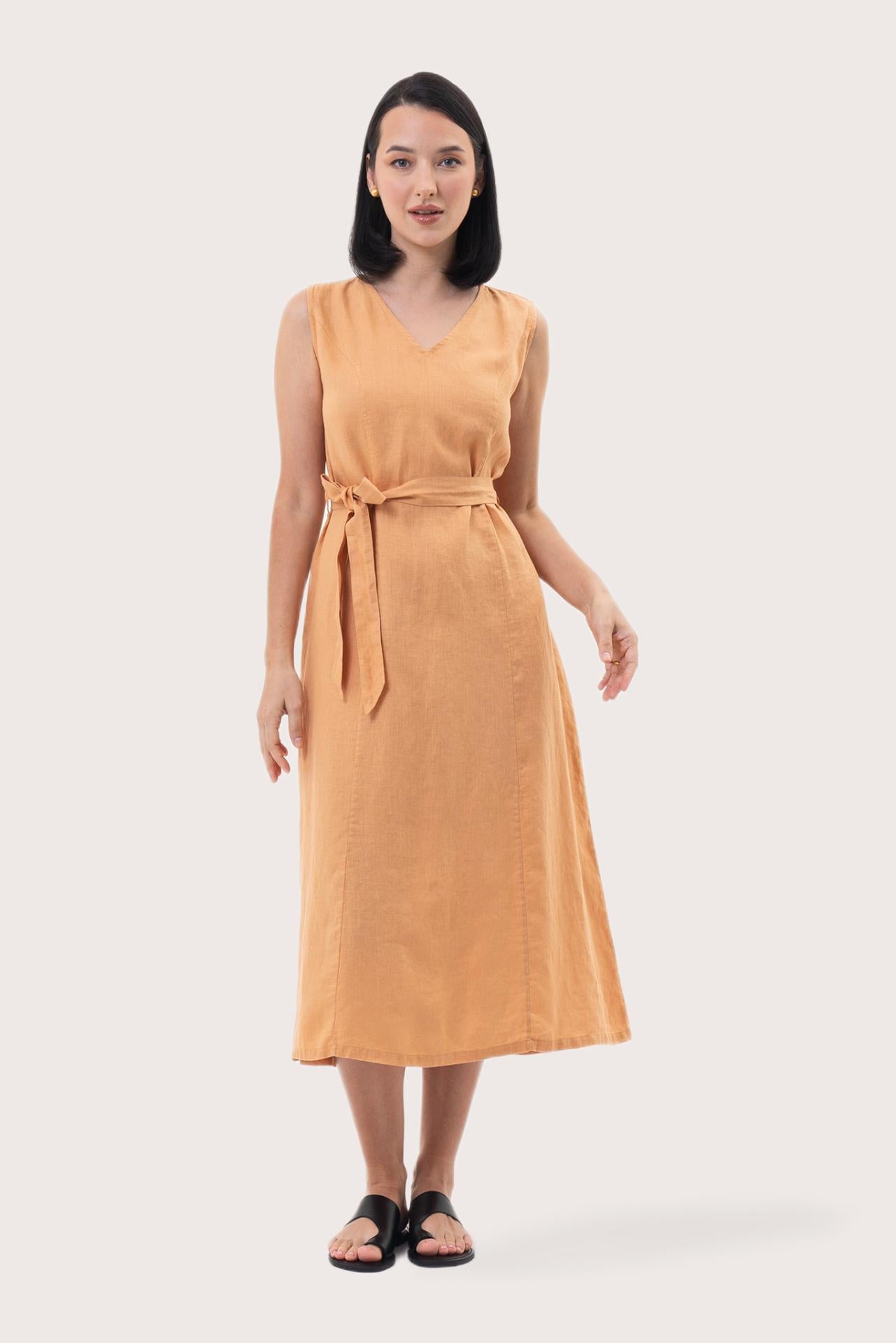 Woman wearing the Eva Linen Midi Dress Light Orange designed for effortless resortwear and tropical living by By The Sea Bali