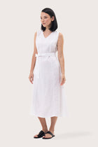 Side profile of the Eva Linen Midi Dress White showing its cut and natural movement