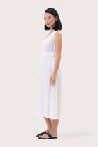Side profile of the Eva Linen Midi Dress White showing its cut and natural movement