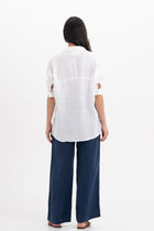 Back view of the Faye Linen Shirt White highlighting the garment shape and drape.