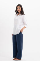 Side profile of the Faye Linen Shirt  White showing its cut and natural movement.
